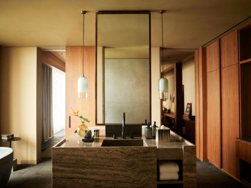 a bathroom with a sink and a mirror at Rosewood Mandarina in Monteón
