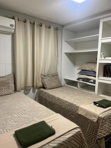 a room with two beds and a window at Vista Real - cobertura com 160m2 - Piscina privada in João Pessoa