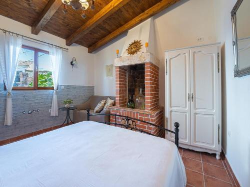 a bedroom with a bed and a fireplace at Charming Villa with Private Garden & BBQ in Barban