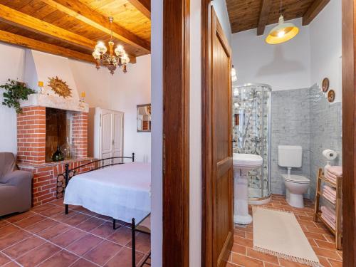 a bedroom with a bed and a bathroom at Charming Villa with Private Garden & BBQ in Barban