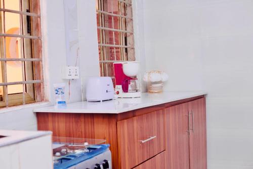 a kitchen with a counter with appliances on it at Villa de chez nous in North Legon