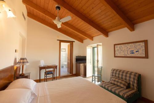 a bedroom with a bed and a chair at Agriturismo Villa Fiore in Torano Nuovo