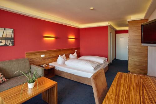 a hotel room with a bed and a couch at Hotel Schloss Berg in Berg am Starnberger See