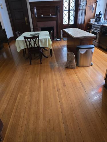 a dining room with a table and a kitchen at Summer Street Guest House in Buffalo