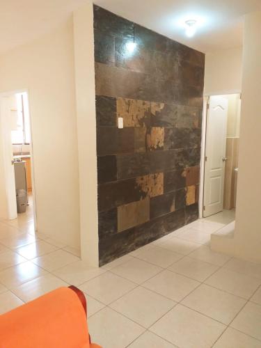 a living room with a wall made of wood at Urbanization Maratea in Manta