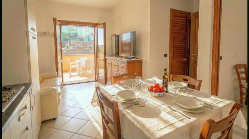 a kitchen with a table with a white table cloth at Cavour Apartment With Terrace in Palau