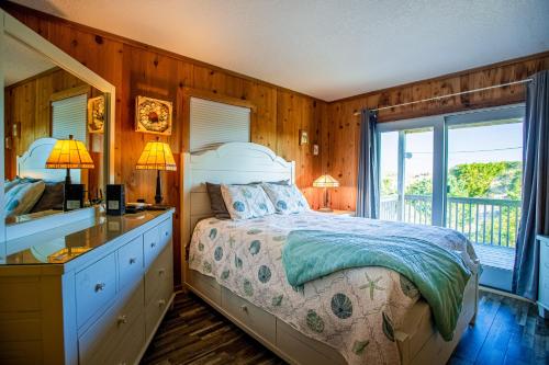 a bedroom with a bed and a dresser and a window at AVWI1 Beach Stars #1-WI in Avon