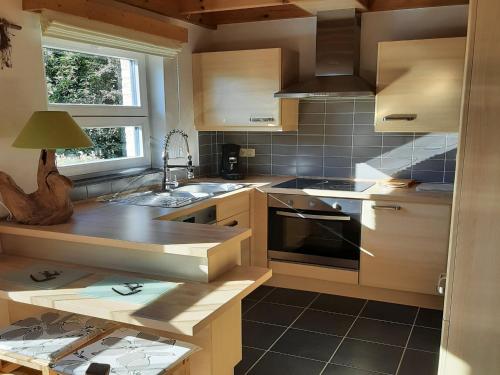 a kitchen with a sink and a stove top oven at Cottage in Durbuy with Terrace, Garden in Durbuy
