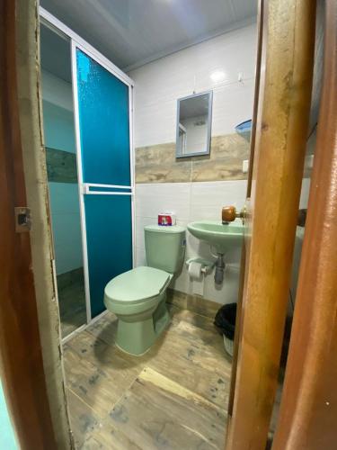 a bathroom with a toilet and a sink at Hotel Y Transporte LadyMar in Nuquí