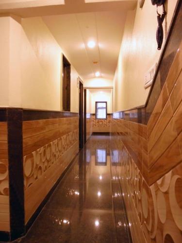 a hallway of a building with wood flooring at Hotel Great Western in Kolkata