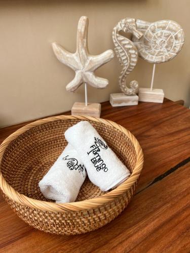 a basket with towels and a starfish on a table at Flamingo Blue - Casa Boutique - Adults Only in El Cuyo
