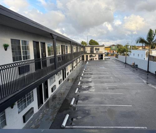 an empty parking lot next to a building at The Atlas Inn & Suites LAX in Inglewood