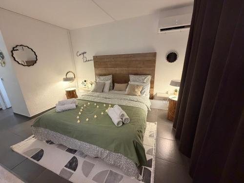 a bedroom with a large bed with towels on it at Studio Les Marines V - calme - vue sur le golf in Saint-François