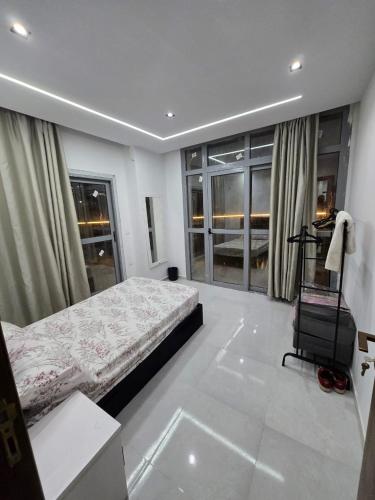 a bedroom with a bed and a chair in it at رويال جاردن سويت in Cairo