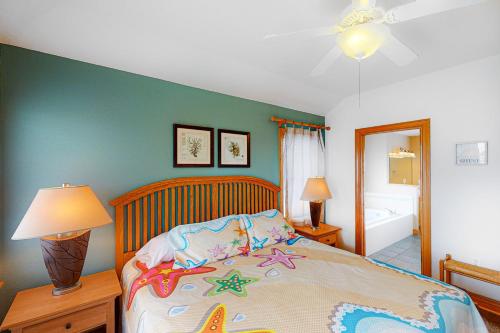 a bedroom with a bed and a bathroom at BXOLRD2 Native Sun #9-BB in Buxton