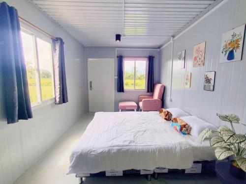 a bedroom with a large bed with a dog laying on it at Bake for You Camping in Ban Nong Bua