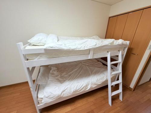a white bunk bed in a room at サクセスハイム 203 in Miyazaki