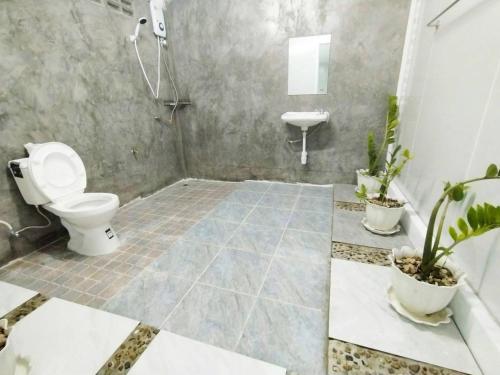 a bathroom with a toilet and a sink at Bake for You Camping in Ban Nong Bua