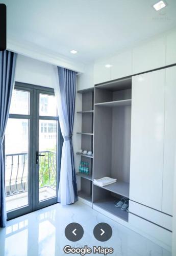 a living room with a large window and a table at 6668 Hotel - Chi nhánh 2 in Tây Ninh