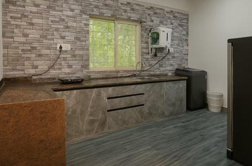 a kitchen with a sink and a window at Irida 2bhk private pool viila in Assagao