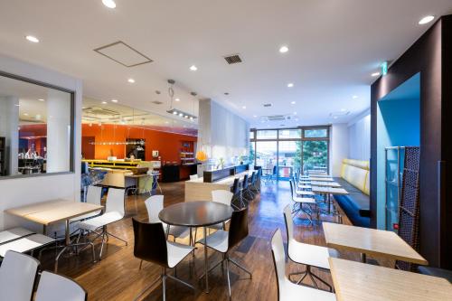 a restaurant with tables and chairs and a bar at Hotel 1-2-3 Takasaki in Takasaki