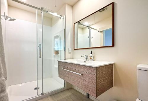 a bathroom with a sink and a shower at Hahei Island Views in Hahei