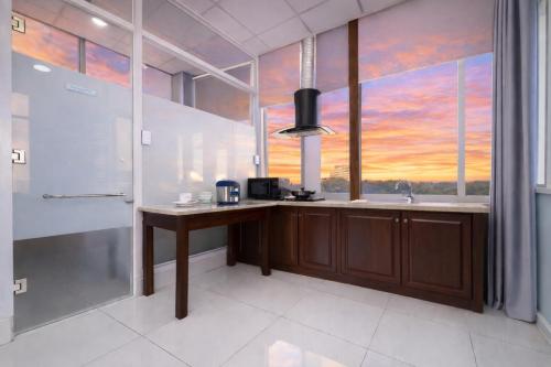 a bathroom with a sink and a large window at Diamond Luxury Ben Thanh in Ho Chi Minh City