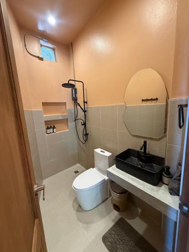 a bathroom with a white toilet and a sink at The Petra Boutique Studios in Ko Tao