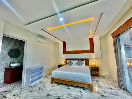 a hotel room with a bed and a window at Agustik Villas in Badung