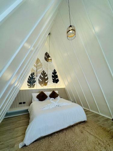 a bedroom with a bed in a attic at Solsticio Azzul Beach Resort in Pandan