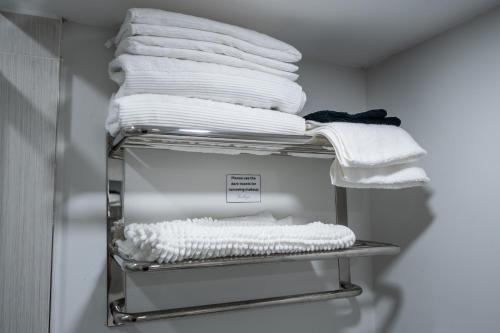 a stack of towels on a shelf in a closet at Newly Renovated 2BR Basement Suite, Private Entry in Pickering