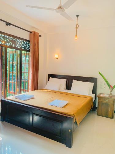 a bedroom with a large bed in a room at Orange Jesmine Unawatuna in Unawatuna