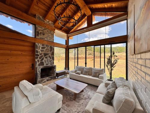 a living room with couches and a fireplace at BOSK TAPALPA - Cabaña en Tapalpa in Tapalpa