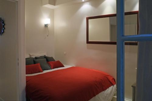 a bedroom with a bed with a mirror and a ladder at Apartment Bac St. Germain in Paris