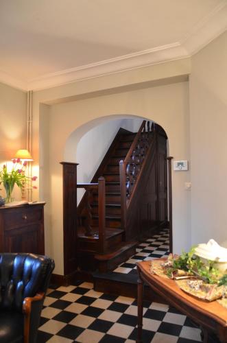 a living room with a stairway with a table and a room at Le Petit Maur in Spa