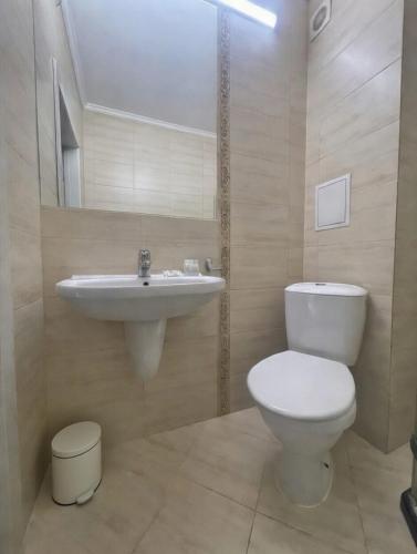a bathroom with a toilet and a sink at ESKADA Apartments in Ahtopol