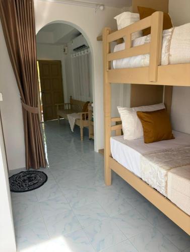 a bedroom with a bunk bed and a living room at Penn house with shared pool in Ko Raeng
