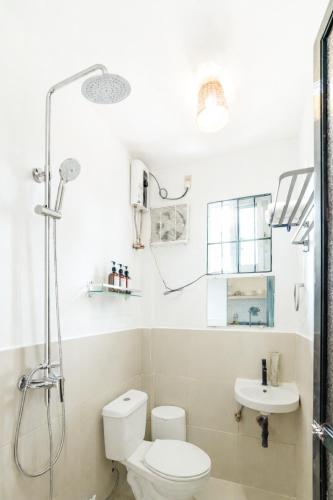 a bathroom with a shower and a toilet and a sink at Bijunas Homestay in General Luna