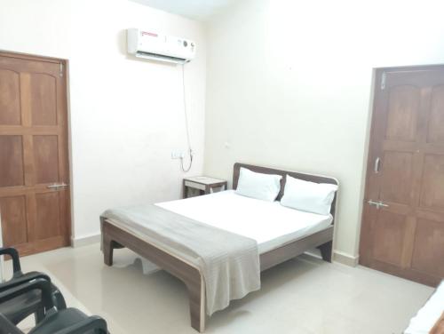 a small bedroom with a bed and a window at Rich nest apartments colva in Colva