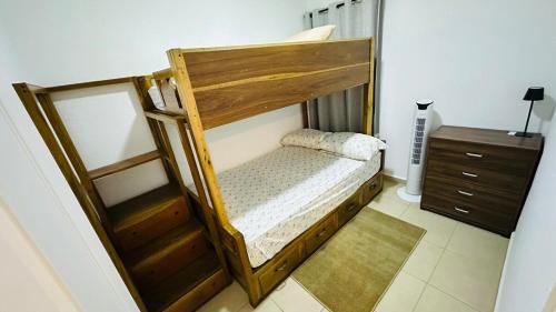 a bedroom with a wooden bunk bed with a dresser at Casa de Sasha in El Matazano