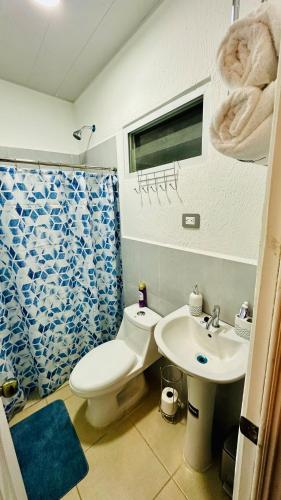 a bathroom with a toilet and a sink at Casa de Sasha in El Matazano