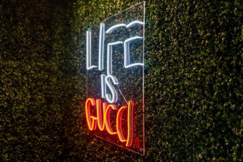 a neon sign on the side of a wall at The Gawdy Den with Fast WIFI 2 minutes from Downtown Houston! in Houston