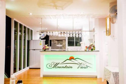 a kitchen with a counter with a refrigerator at Namthip Residence in Trang