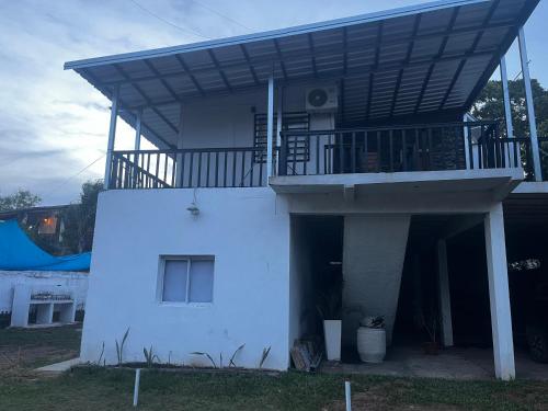 a white house with a balcony on top of it at V&V House in Concordia