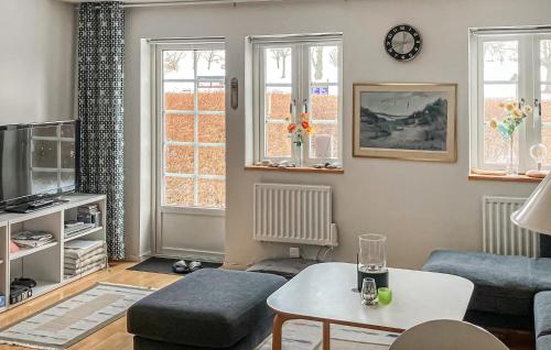 a living room with a couch and a table at 3 Bedroom Beautiful Home In Simrishamn in Simrishamn