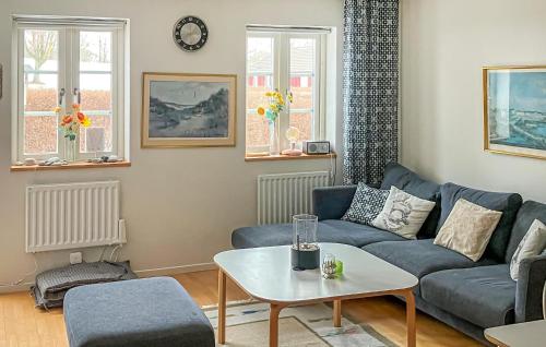 a living room with a couch and a table at 3 Bedroom Beautiful Home In Simrishamn in Simrishamn
