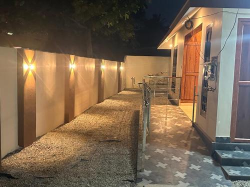 a hallway of a house at night with lights at SBJ Road House in Varkala