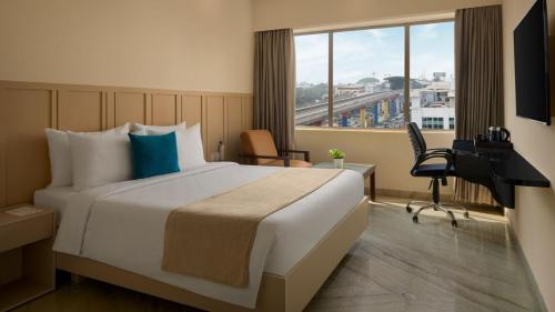 a hotel room with a large bed and a window at The Fern Residency Bengaluru, Yeshwanthpur, Series by Marriott in Bangalore