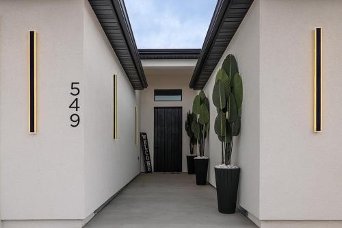 a hallway with potted plants and a skylight at The Mustang Collection 49 in Page