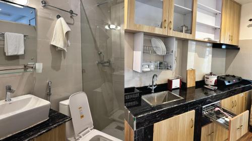 a bathroom with a sink and a shower and a toilet at The Staycation Pokhara in Pokhara